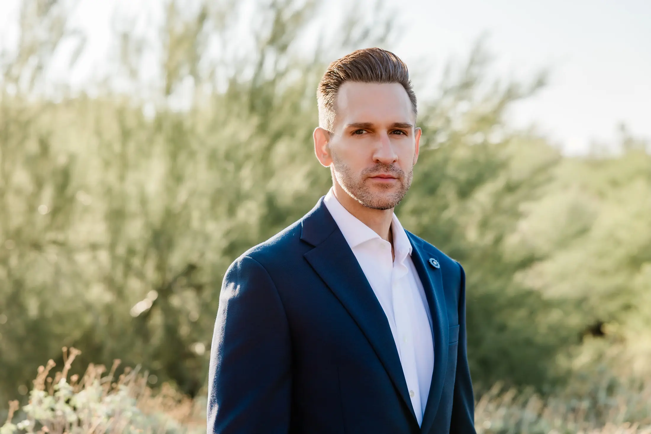 Michael Christopher, MD, standing in the Sonoran desert in a navy jacket.